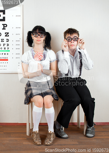 Image of Two person wearing spectacles in an office at the doctor