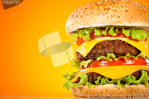 Image of Tasty and appetizing hamburger on a yellow