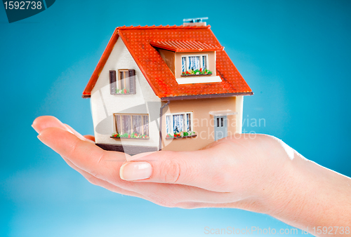 Image of house in human hands