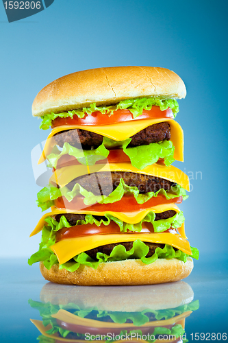Image of Tasty and appetizing hamburger on a blue
