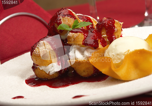 Image of Tasty profiteroles on a dining table 