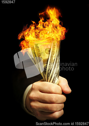 Image of man's hand holds dollars