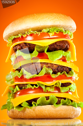 Image of Tasty and appetizing hamburger on a yellow