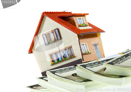 Image of house on packs of banknotes