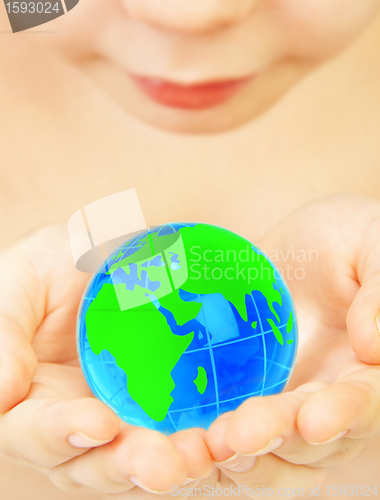 Image of boy holds globe in hands