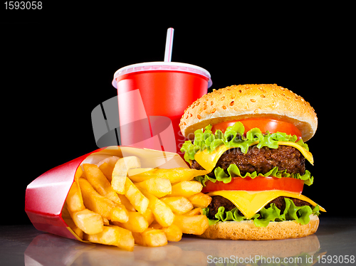 Image of Tasty hamburger and french fries on a dark