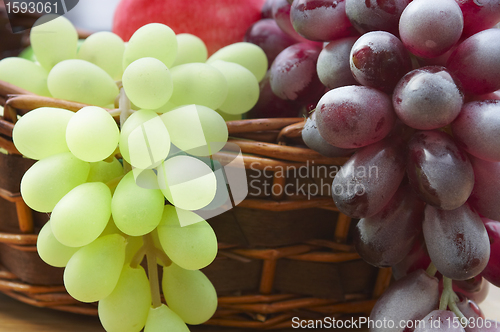 Image of Red and white grape branch in a basket 