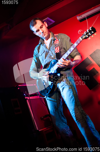 Image of musician plays a guitar