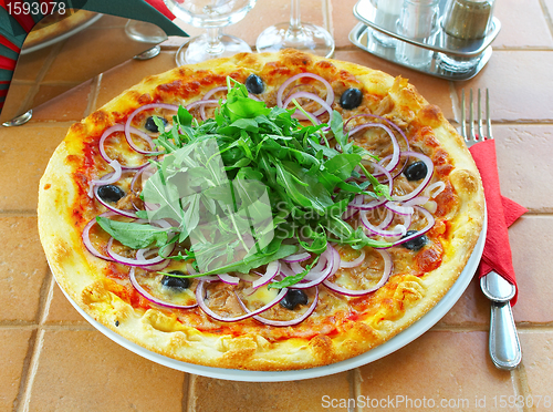 Image of Hot pizza on a table in cafe 