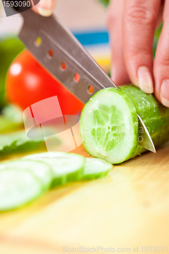 Image of Woman's hands cutting vegetables