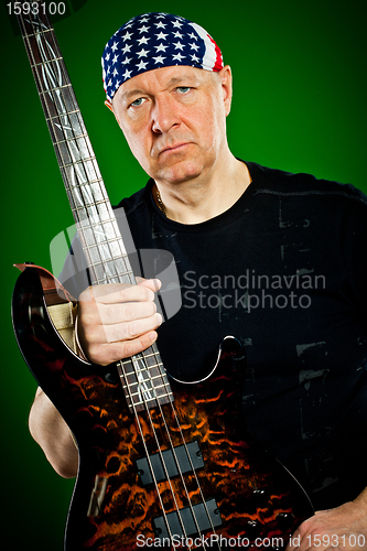 Image of man with a guitar, bass player