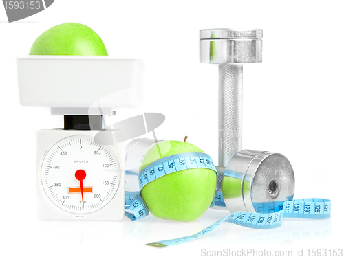 Image of Dumbbells and apple. A healthy way of life