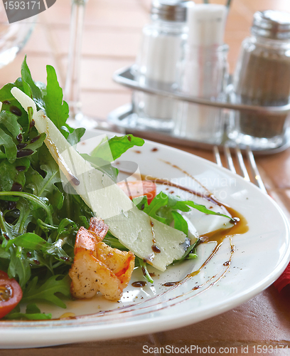 Image of Fresh salad with a tomato, cheese and the fried meat