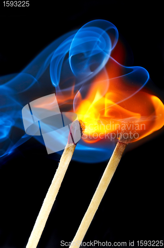 Image of Photo of a burning match in a smoke on a black background