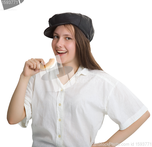 Image of Portrait of a naughty girl in a cap with a bagel in his hand