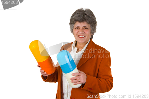 Image of Female senior with two big size pills 