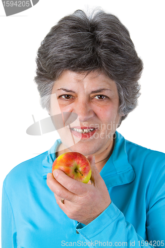 Image of Female senior eating a fresh apple