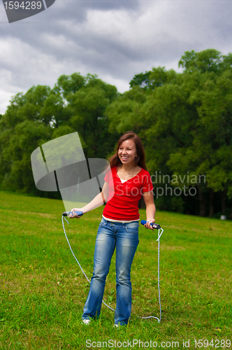 Image of Young woman with skipping rope