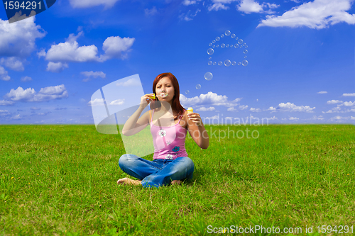 Image of girl blowing soap bubbles