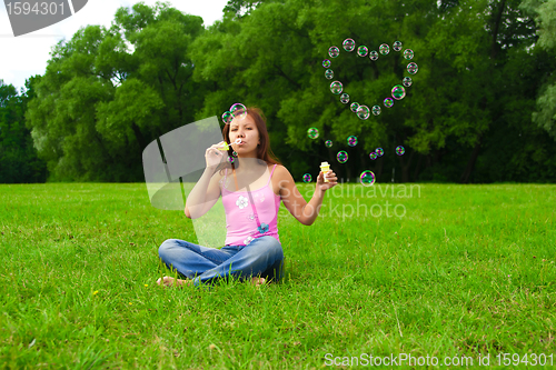 Image of girl blowing soap bubbles