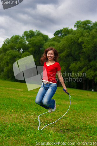 Image of Young woman with skipping rope