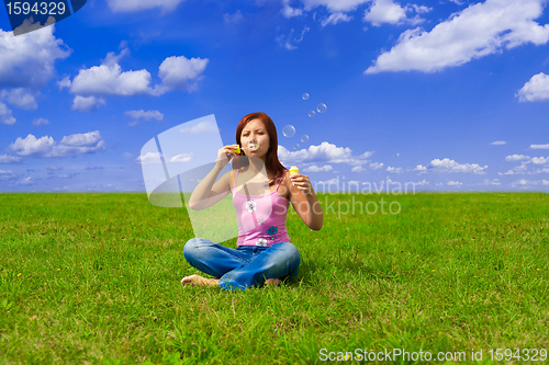 Image of girl blowing soap bubbles