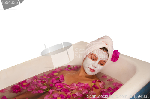 Image of beautiful woman enjoying floral bath