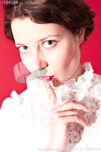 Image of woman with silence gesture 