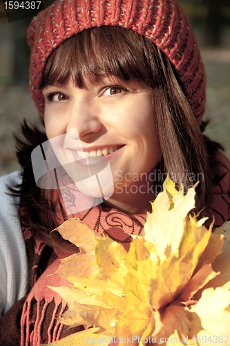 Image of woman with autumn orange leaves