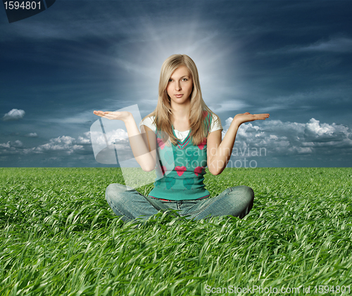 Image of Blonde in lotus pose in green grass