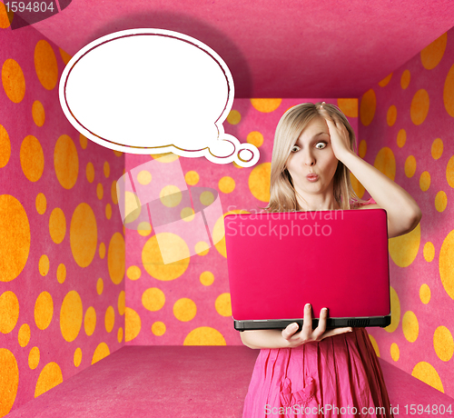 Image of blonde in pink dress with laptop and bubble