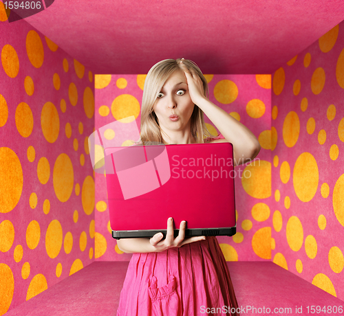 Image of blonde in pink dress with laptop