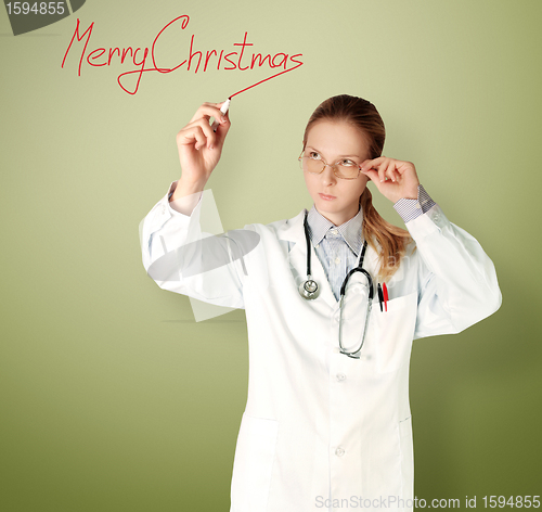 Image of doctor woman writting Merry Christmas