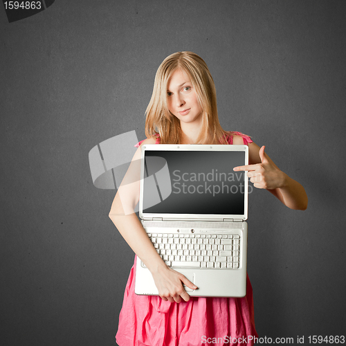 Image of femaile in pink with open laptop