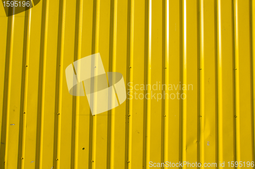 Image of Wall made of yellow wooden planks. 