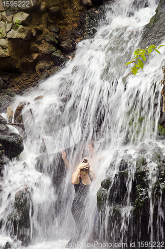 Image of Refreshing under waterfall.