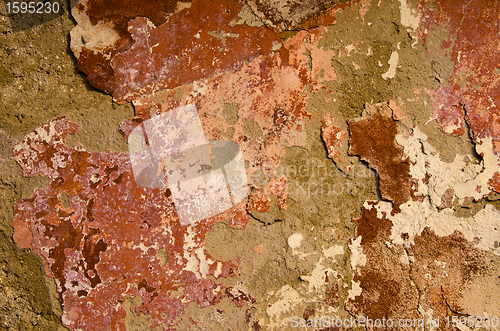 Image of Old painted wall loosing paint.