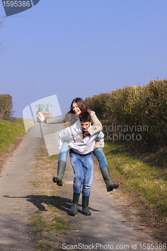 Image of Couple of young people walking in the campaign in spring