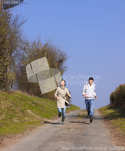 Image of Couple of young people walking in the campaign in spring