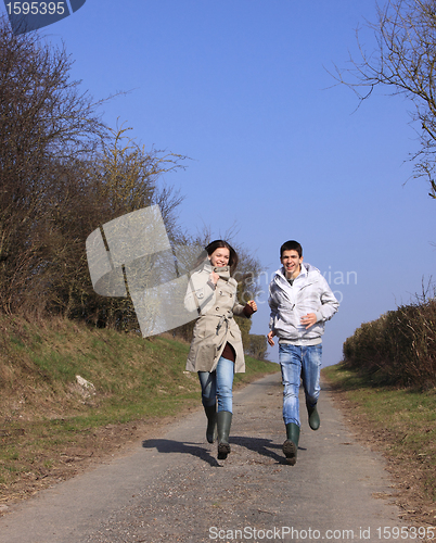 Image of Couple of young people walking in the campaign in spring