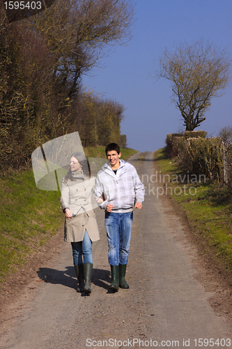 Image of Couple of young people walking in the campaign in spring