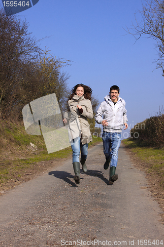 Image of Couple of young people walking in the campaign in spring