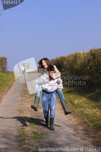 Image of Couple of young people walking in the campaign in spring