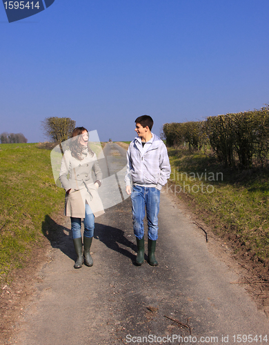 Image of Couple of young people walking in the campaign in spring