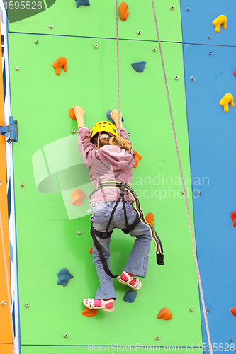 Image of Child climbing on a climbing wall, outdoor