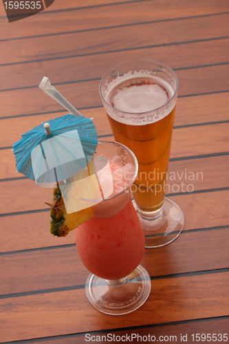 Image of glass of fruit cocktail and a glass of beer