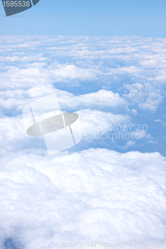 Image of clouds and blue sky seen from plane