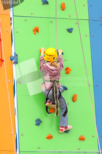 Image of Child climbing on a climbing wall, outdoor