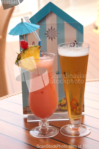 Image of glass of fruit cocktail and a glass of beer