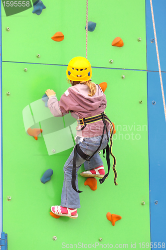 Image of Child climbing on a climbing wall, outdoor